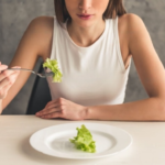 Lady thinking about eating disorder treatment options while eating