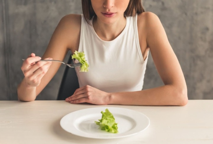 Lady thinking about eating disorder treatment options while eating