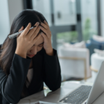 A girl is facing aniexty wile working and looking for Anxiety Management Techniques to calm